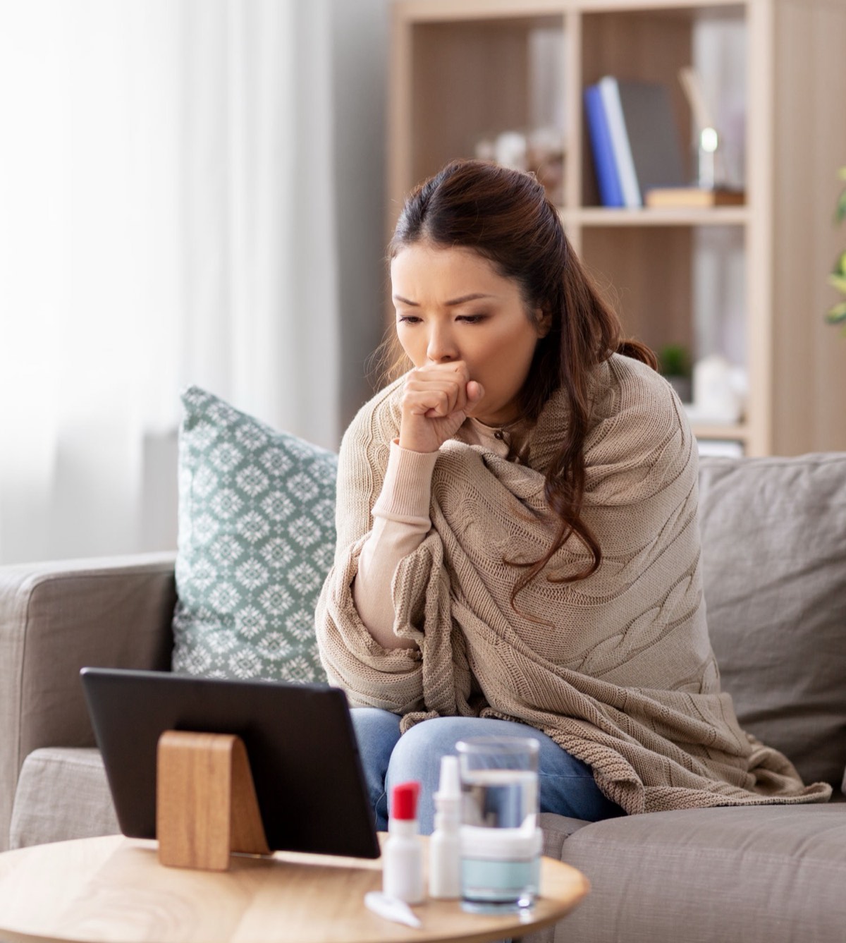 Patient talking to a DoctorsBeyond provider on a tablet from her couch